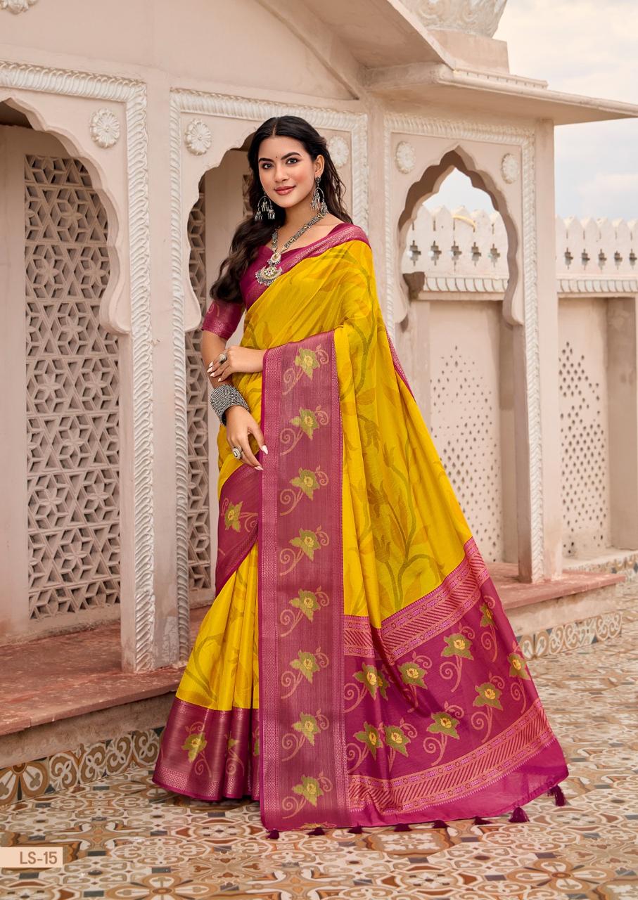 Woman in a yellow and purple saree standing in front of architectural background