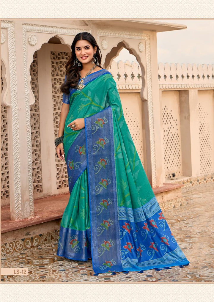 Woman wearing a green and blue saree with a decorative background