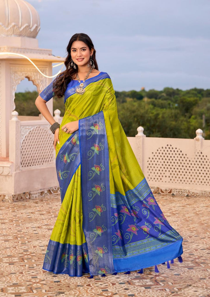 Woman wearing a green and blue saree with a scenic background