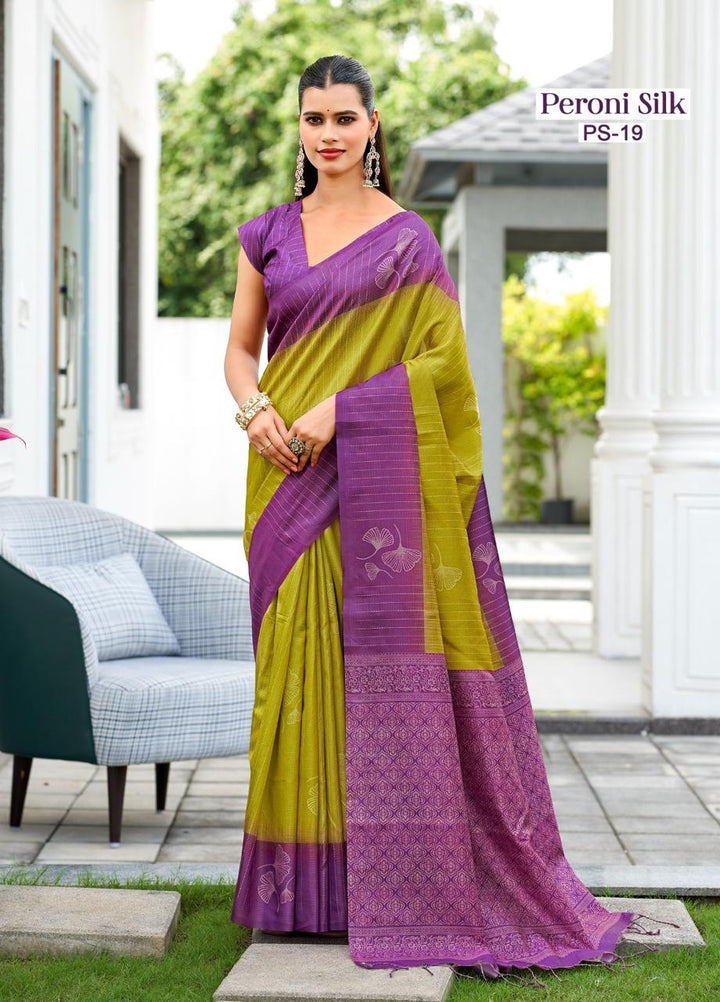 Woman wearing a purple and green saree with 'Peroni Silk' branding.