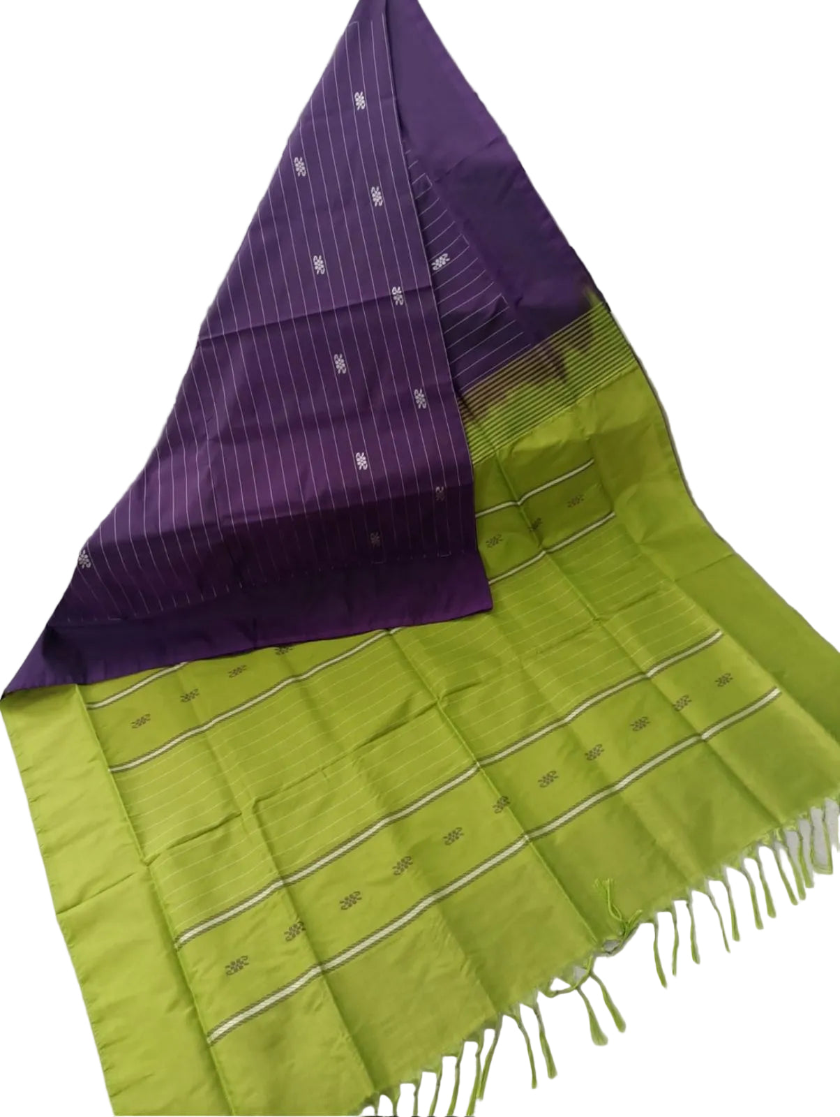 Green and purple checkered fabric draped over a surface with a black and white geometric patterned background.