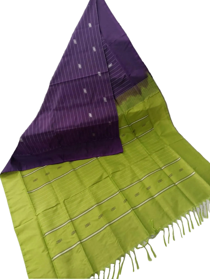 Green and purple checkered fabric draped over a surface with a black and white geometric patterned background.
